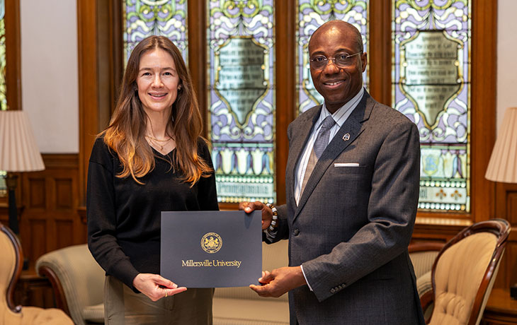 Dr. Wubah congratulates Dr. Sarah Brooks for receiving the Spring Skully's Circle Award