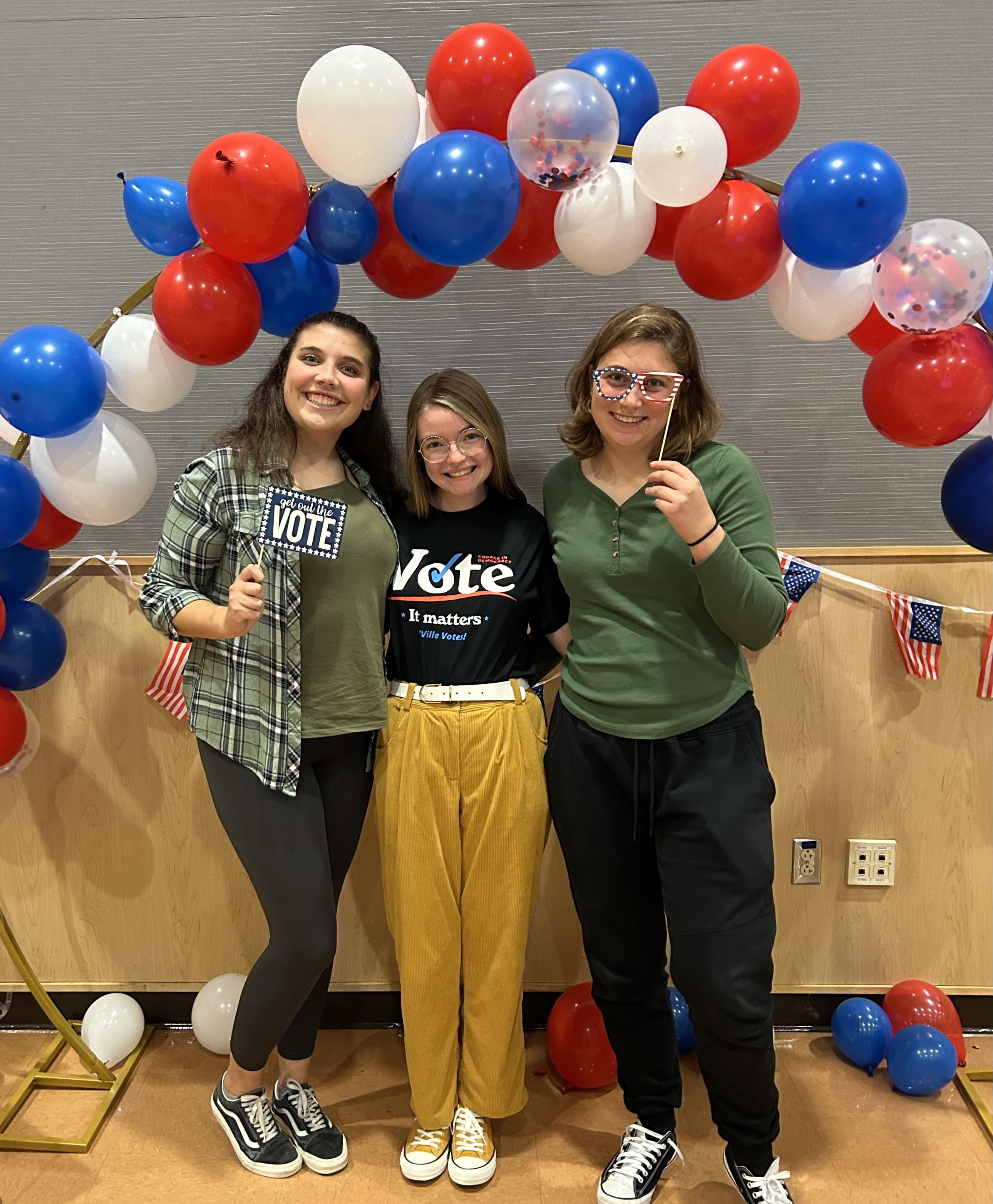 Three students posing at selfie station 