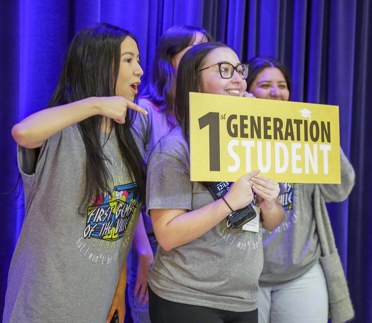 Students holding First-Generation sign