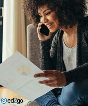 A woman on the phone looking at progress charts